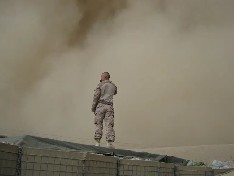 A soldier standing on top of a building.