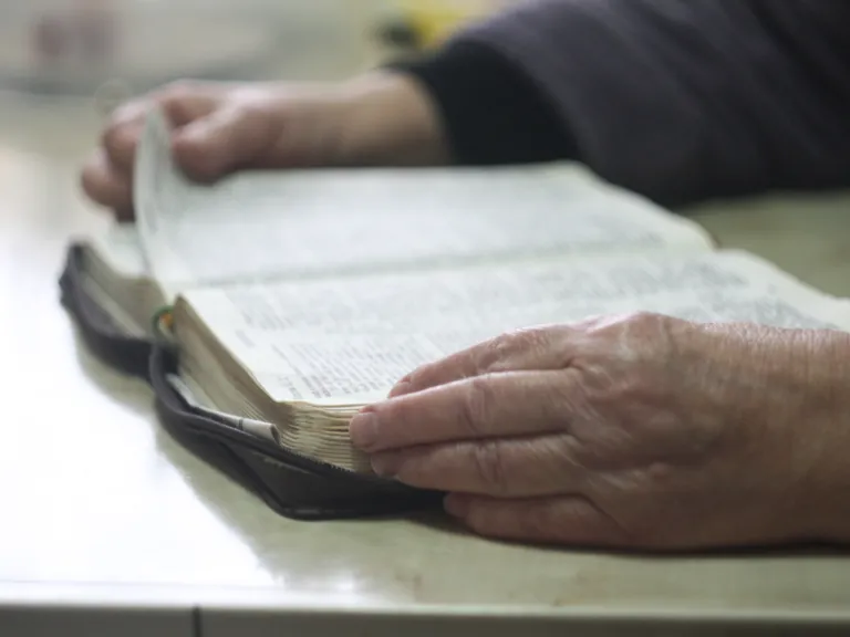 A older person reading a Bible.
