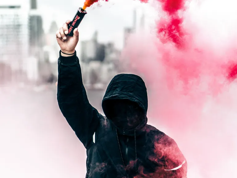 Protester with can of smoke