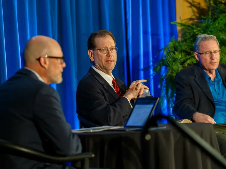 Three men giving a panel presentation