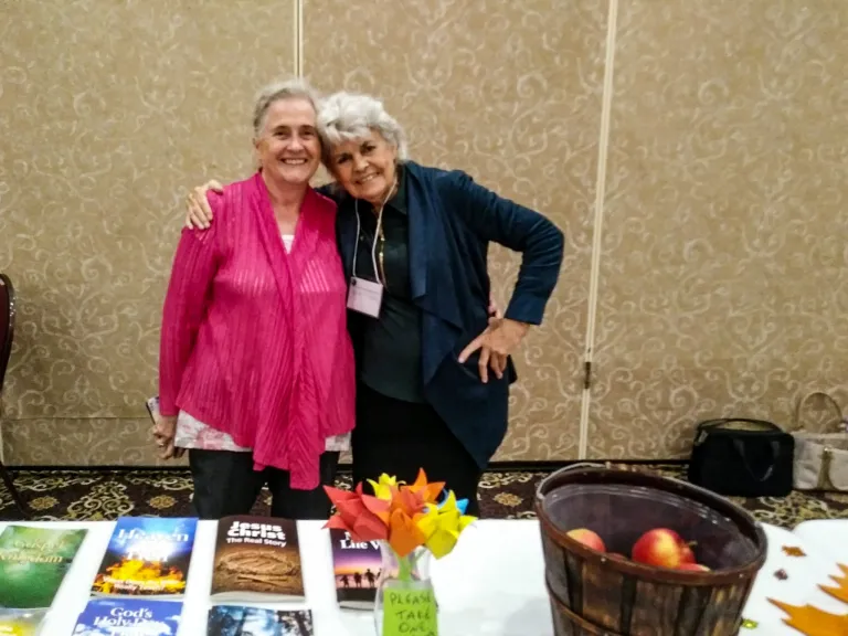 two ladies standing at the information table