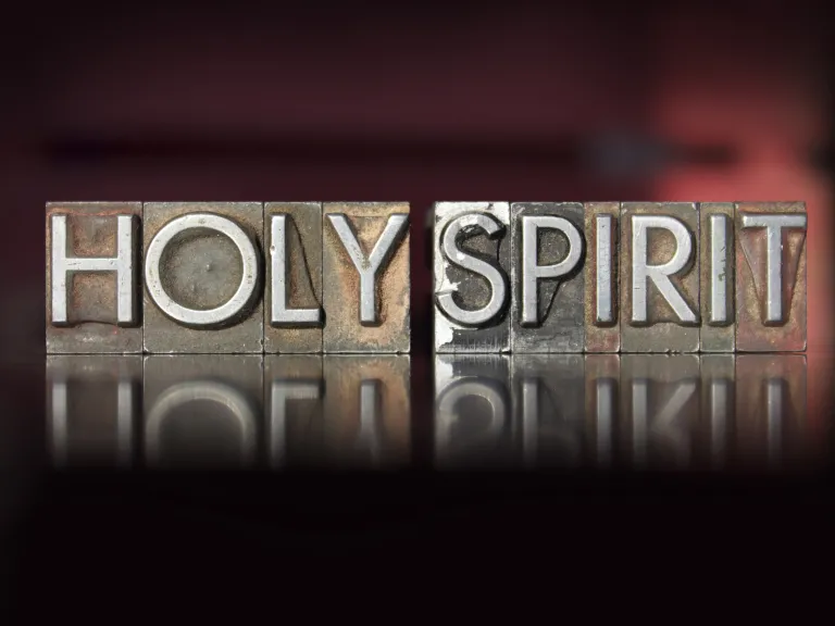 Wood letterpress blocks that spell the word "Holy Spirit".