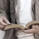 A person reading a Bible.