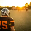 Football player on field at sunset