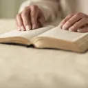 A person reading a Bible.